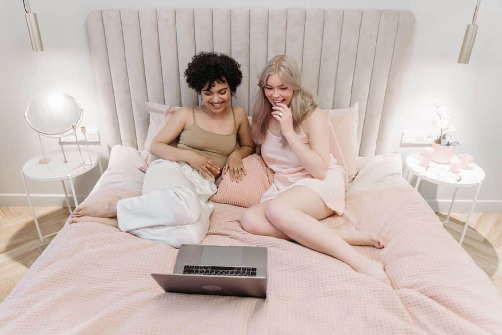 Two women watching something on their laptop